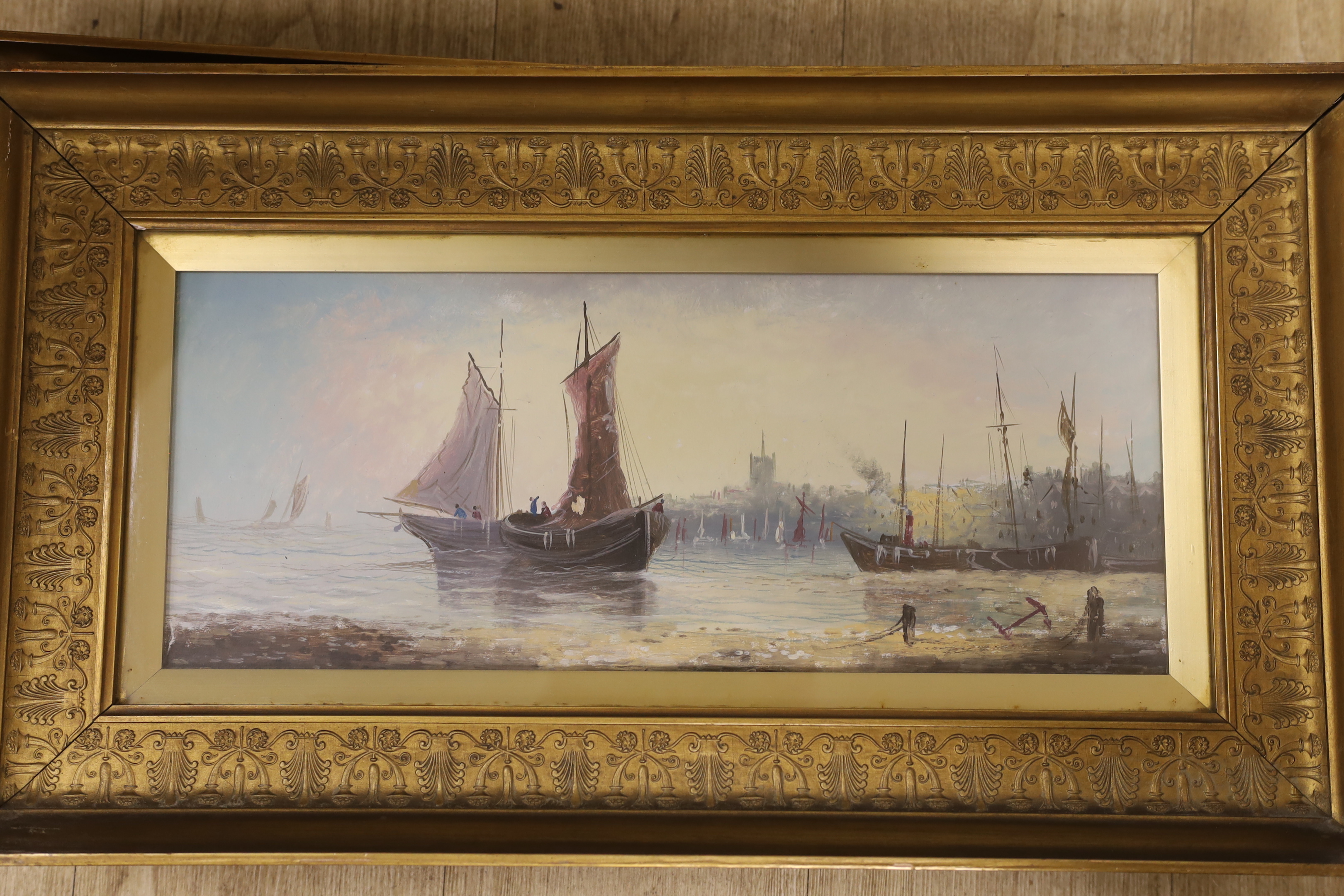 19th century, Continental School, pair of oils on board, Coastal scenes with moored fishing boats, one indistinctly signed, partially obscured by the mount, 18 x 46cm, ornate gilt framed